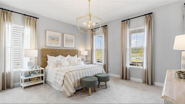bedroom with an inviting chandelier, baseboards, and light carpet
