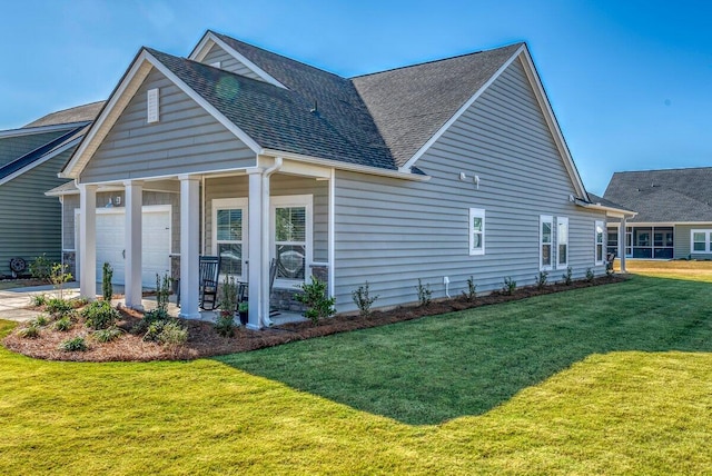 view of home's exterior featuring a lawn and a garage