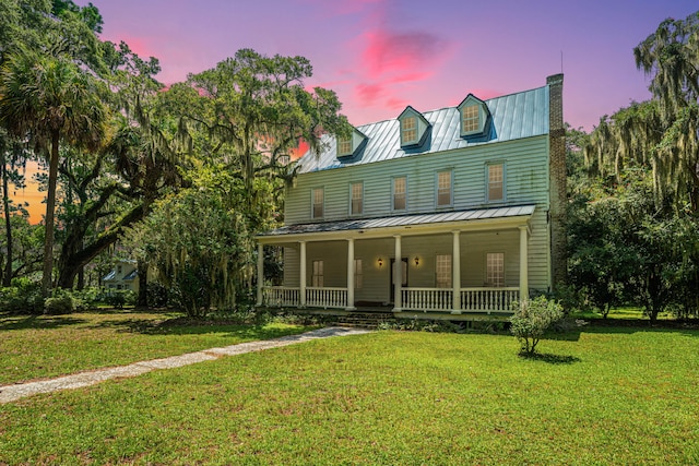 view of front of house with a lawn and covered porch