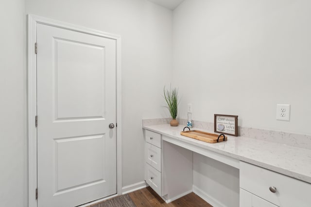 unfurnished office featuring dark hardwood / wood-style floors