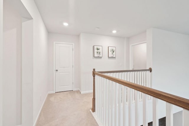 corridor with light colored carpet