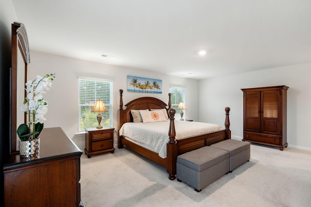 carpeted bedroom featuring multiple windows