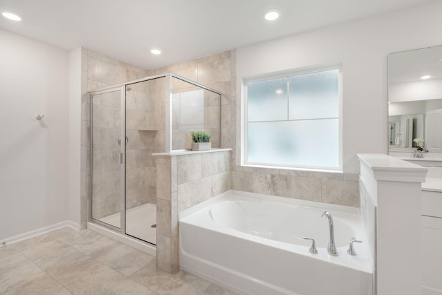 bathroom with vanity and independent shower and bath