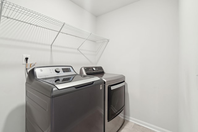 clothes washing area featuring washer and clothes dryer