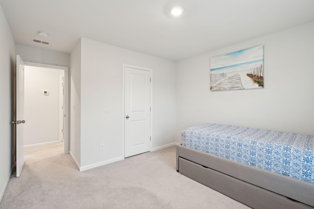 bedroom featuring light carpet