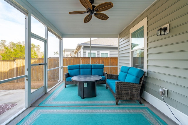 sunroom featuring ceiling fan