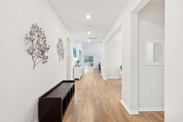 corridor with light wood-type flooring