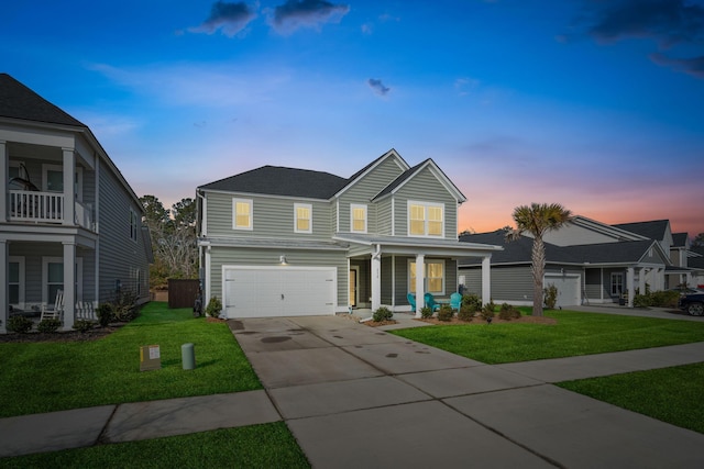 view of property with a garage, a porch, and a yard