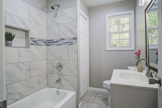 full bathroom featuring toilet, vanity, tiled shower / bath, and tile patterned floors