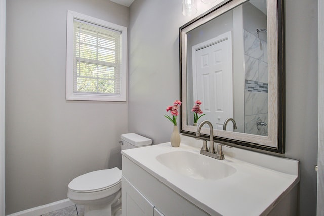 bathroom with toilet, vanity, and tile patterned flooring