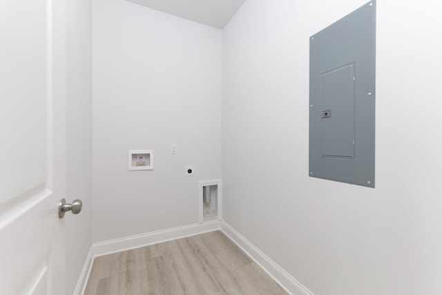 laundry room with light wood-type flooring, hookup for a washing machine, electric panel, and hookup for an electric dryer