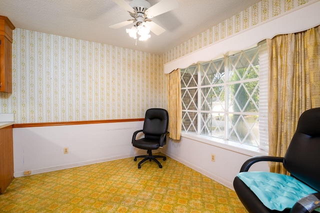 sitting room featuring ceiling fan and a textured ceiling