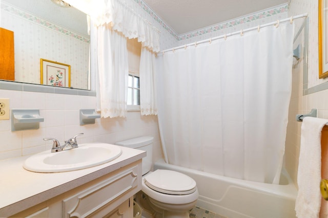 full bathroom featuring vanity, shower / bath combination with curtain, toilet, and tile walls