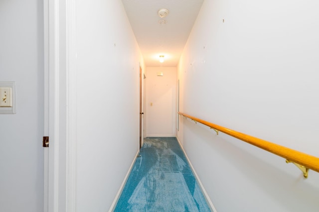 hallway featuring dark carpet