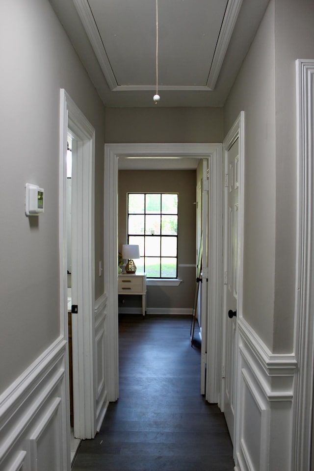 hallway with attic access, dark wood finished floors, and baseboards