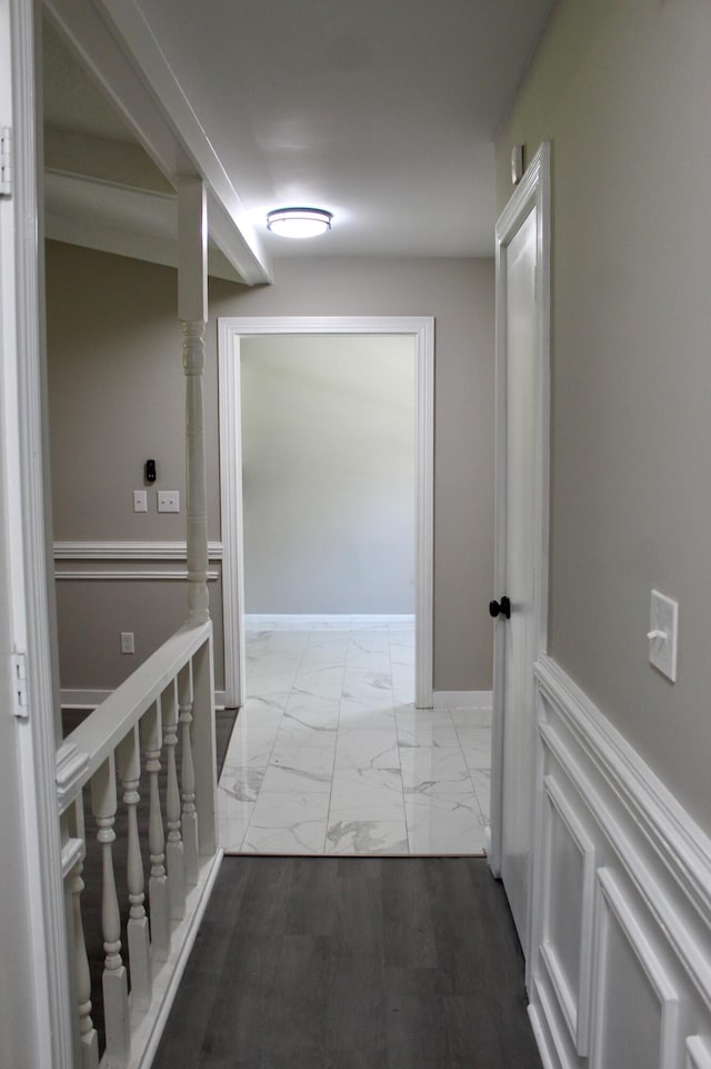 hall featuring light marble finish floors