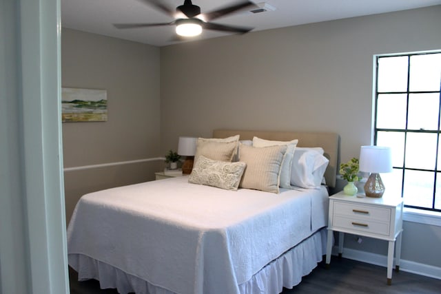 bedroom featuring dark wood-style floors, baseboards, and a ceiling fan