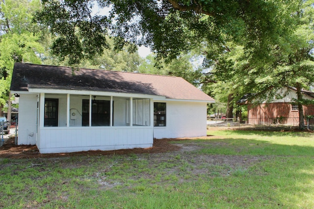 back of property with brick siding and a shingled roof