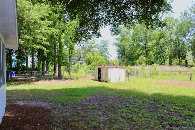 view of yard featuring a storage shed and an outbuilding