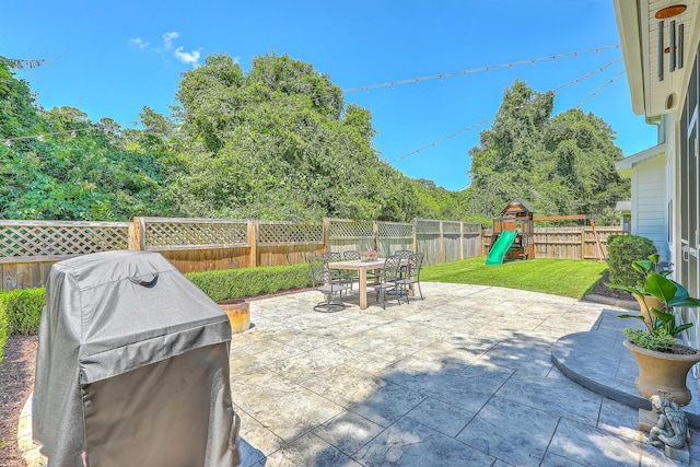 2150 Terrabrook Ln, Charleston, SC 29412 - fenced backyard with outdoor dining space, a patio, a grill, and a playground