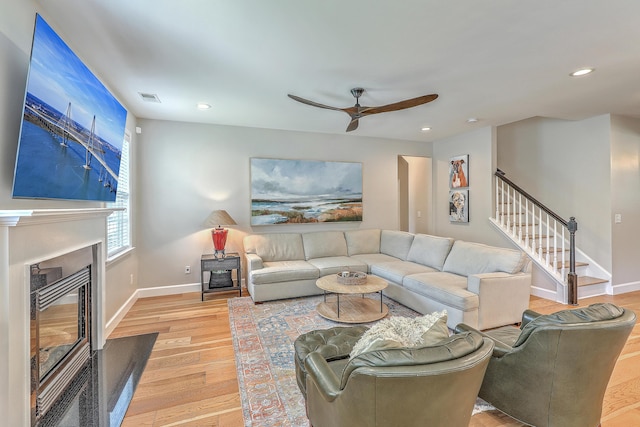 2150 Terrabrook Ln, Charleston, SC 29412 - living room featuring light wood finished floors, stairway, ceiling fan, recessed lighting, and a glass covered fireplace