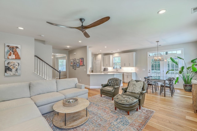 2150 Terrabrook Ln, Charleston, SC 29412 - living room featuring ceiling fan, stairs, recessed lighting, light wood-type flooring, and a chandelier