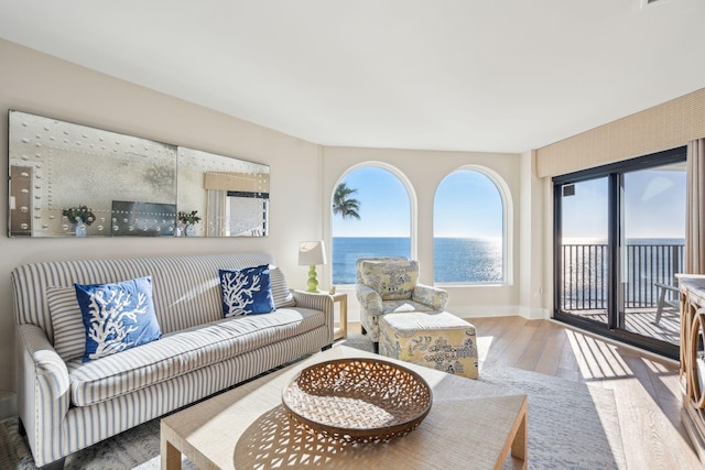 living room featuring a water view and hardwood / wood-style flooring