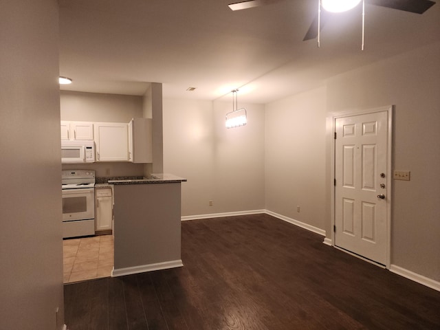 kitchen featuring dark hardwood / wood-style flooring, white appliances, ceiling fan, white cabinets, and pendant lighting