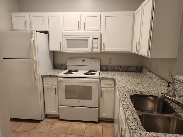 kitchen with white cabinetry, white appliances, sink, and light tile patterned flooring