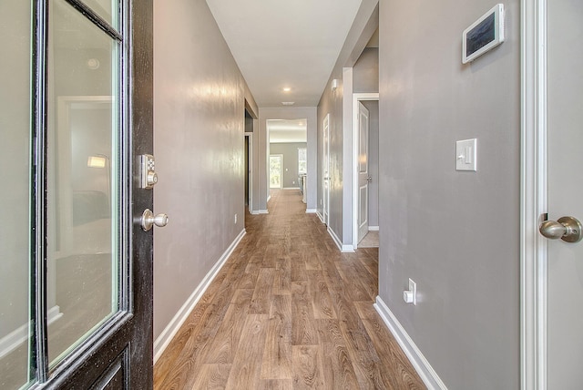 hallway with light wood-type flooring