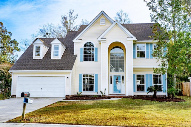 view of front of property featuring a front yard and a garage