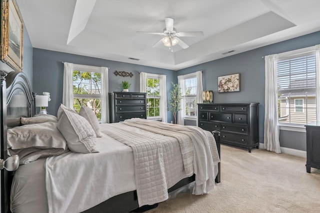129 Saluda Dr, Moncks Corner, SC 29461 - bedroom with a raised ceiling, light carpet, multiple windows, and ceiling fan