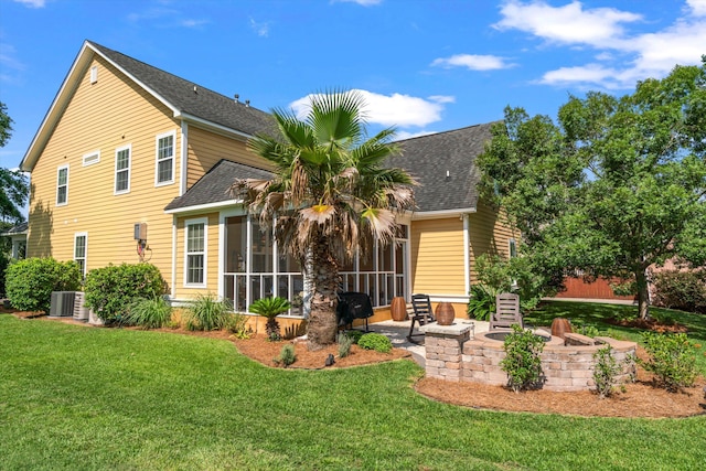 129 Saluda Dr, Moncks Corner, SC 29461 - view of front of property with a sunroom, a shingled roof, a front lawn, and a patio area