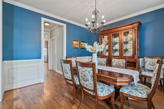 129 Saluda Dr, Moncks Corner, SC 29461 - dining area featuring a chandelier, wood finished floors, wainscoting, and ornamental molding