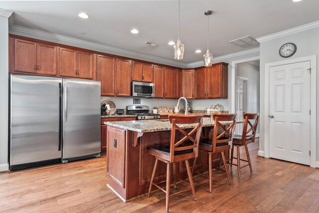 129 Saluda Dr, Moncks Corner, SC 29461 - kitchen with appliances with stainless steel finishes, ornamental molding, light stone countertops, brown cabinetry, and pendant lighting