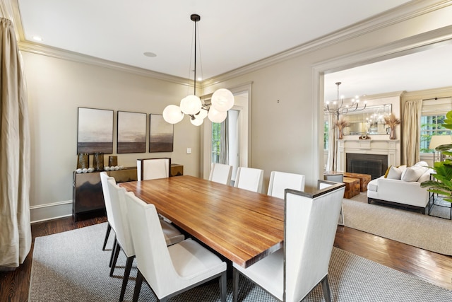 dining space featuring ornamental molding, dark hardwood / wood-style floors, and an inviting chandelier