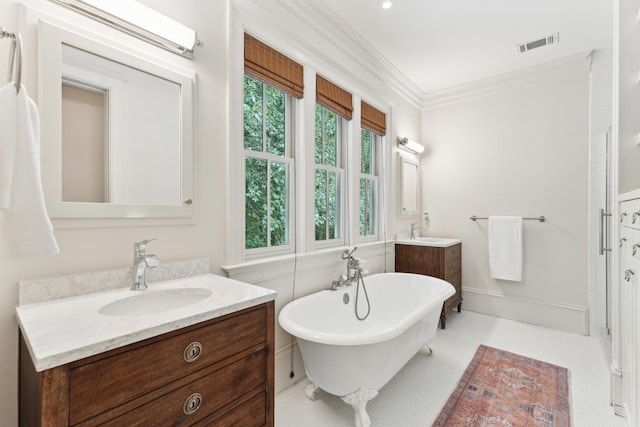 bathroom featuring ornamental molding, a bathtub, and vanity