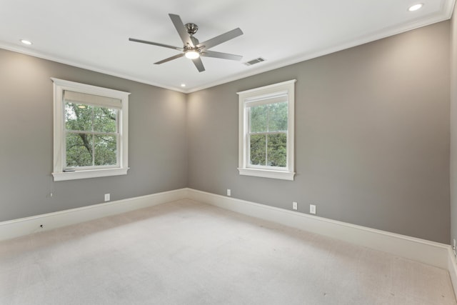 empty room featuring ornamental molding, light carpet, and ceiling fan