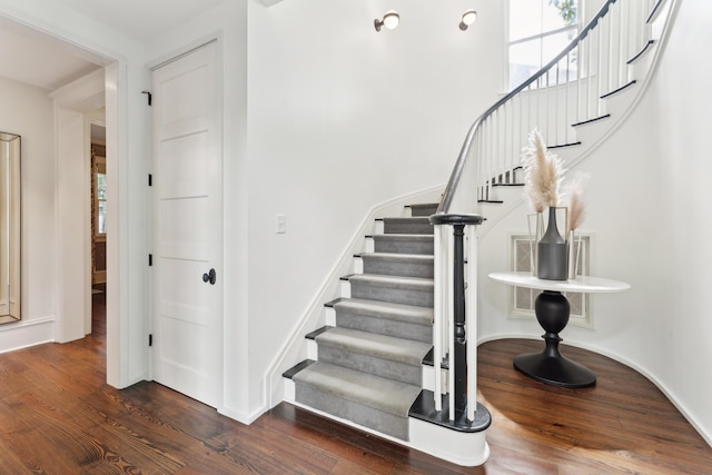 stairway with hardwood / wood-style floors