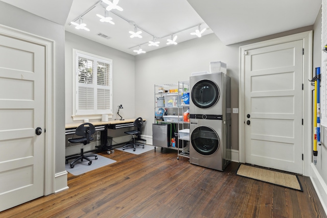 clothes washing area with stacked washer and dryer and dark hardwood / wood-style flooring