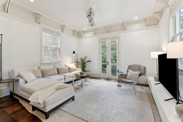 living room featuring a wealth of natural light, french doors, and wood-type flooring