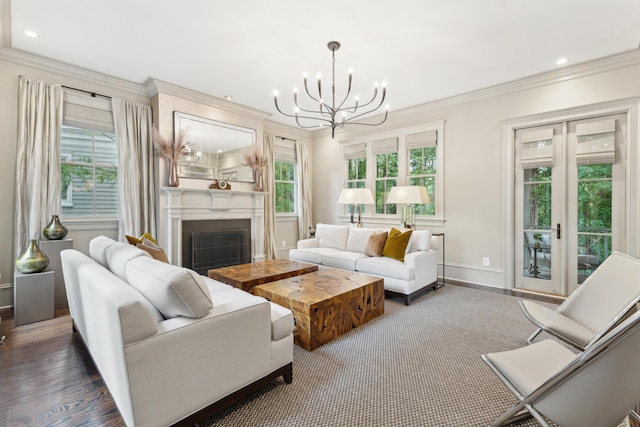 living room featuring dark hardwood / wood-style flooring, a notable chandelier, and crown molding