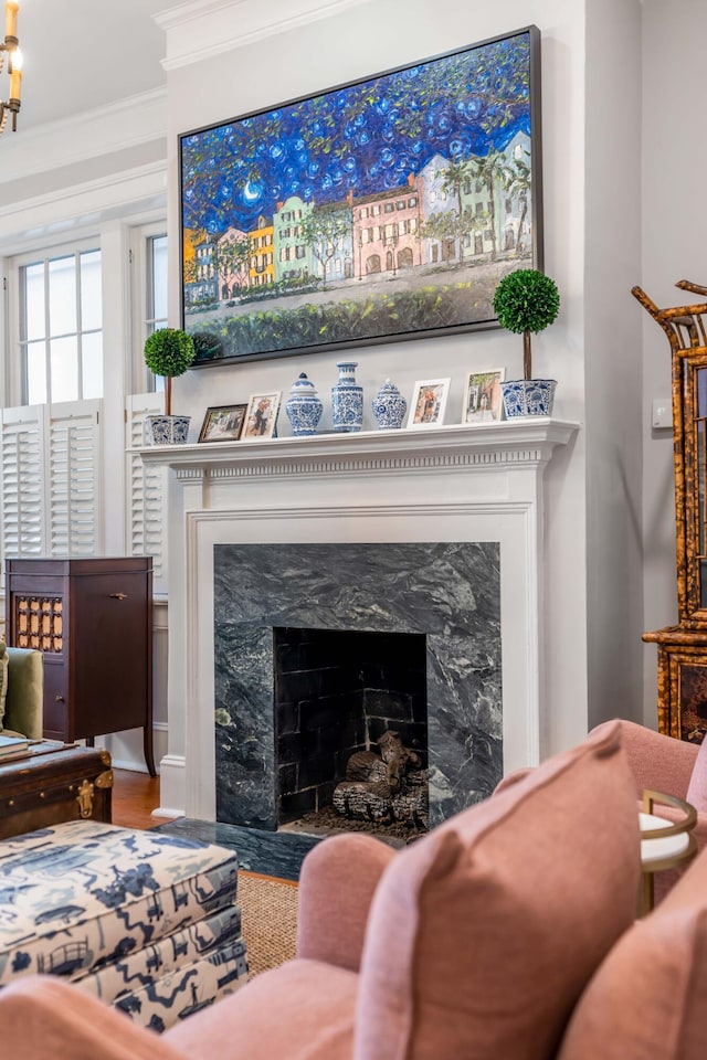 living room featuring hardwood / wood-style flooring, a fireplace, and ornamental molding