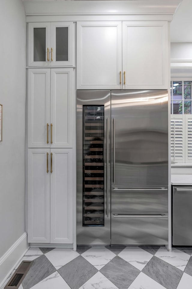 kitchen with white cabinetry and high end fridge