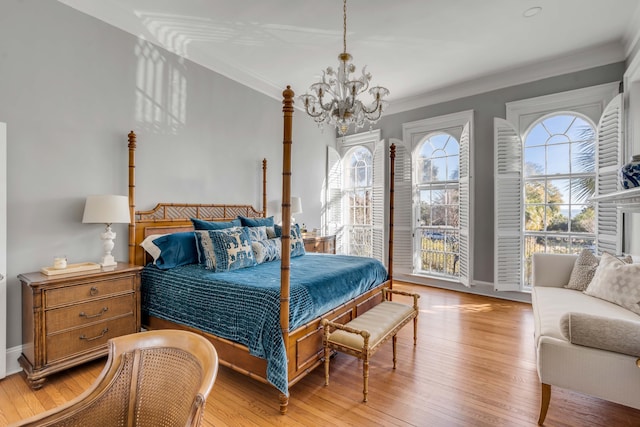 bedroom featuring a notable chandelier, light hardwood / wood-style flooring, and ornamental molding