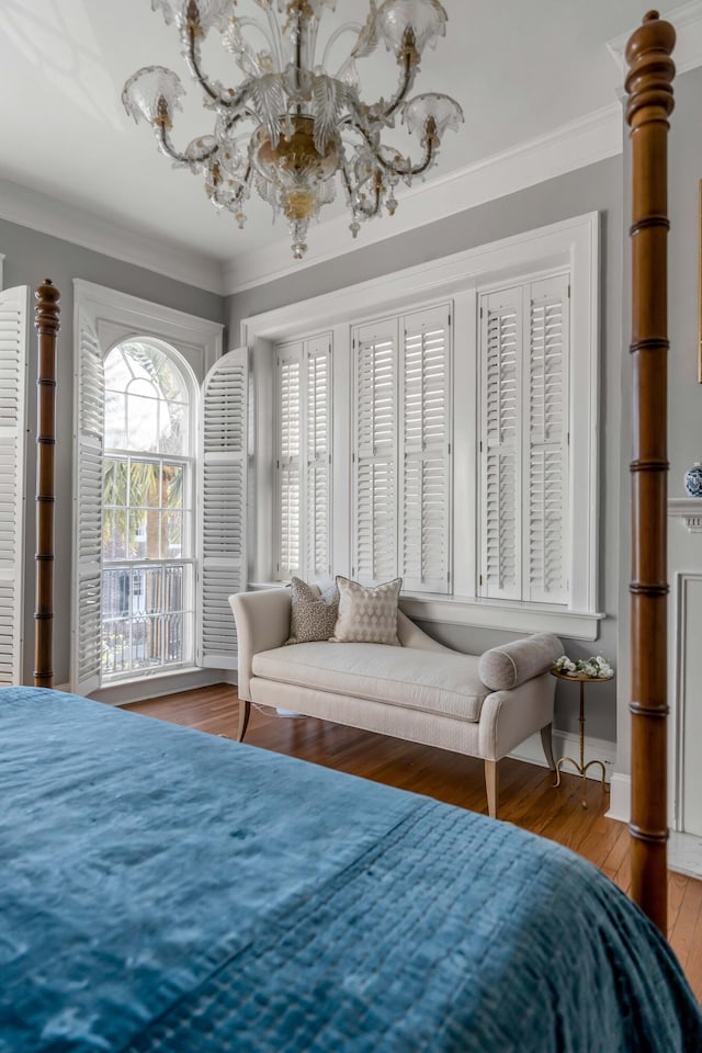 bedroom with hardwood / wood-style flooring and ornamental molding