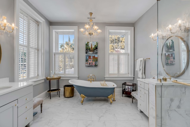 bathroom with a washtub, vanity, and a chandelier