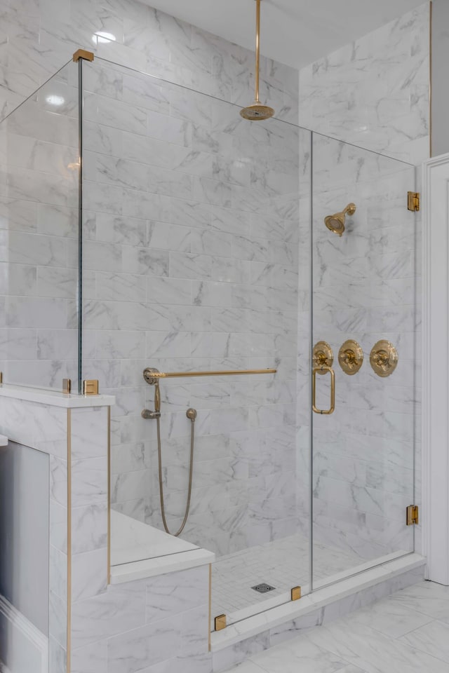 bathroom featuring a shower with shower door