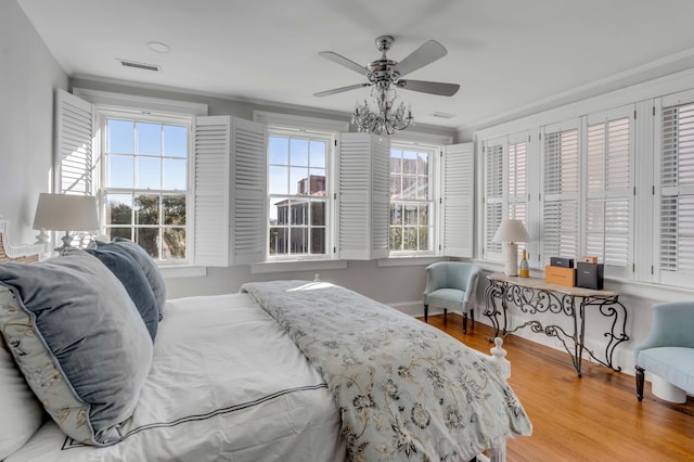 bedroom with ceiling fan and wood-type flooring