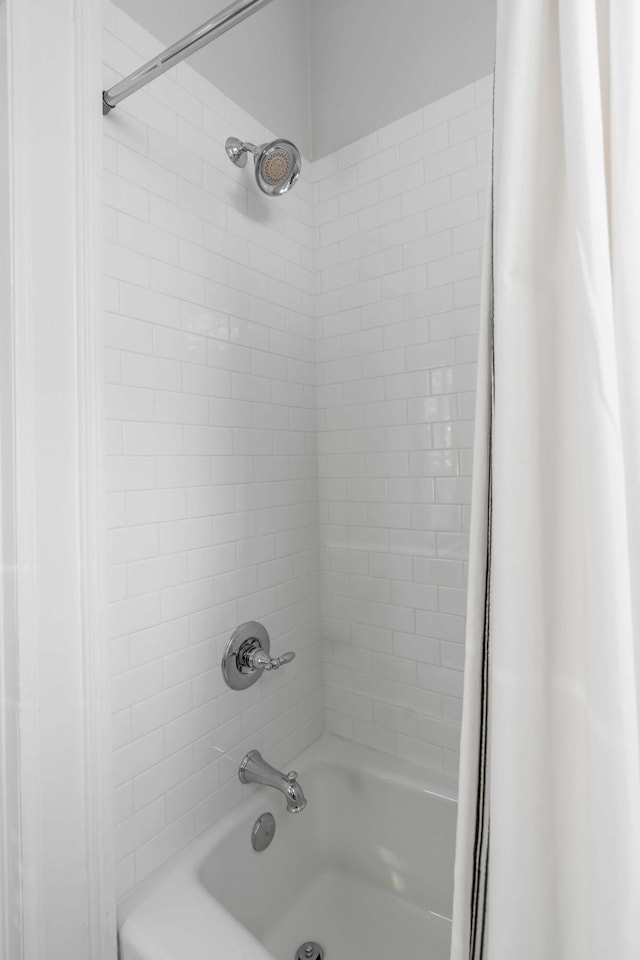 bathroom with shower / bathtub combination with curtain